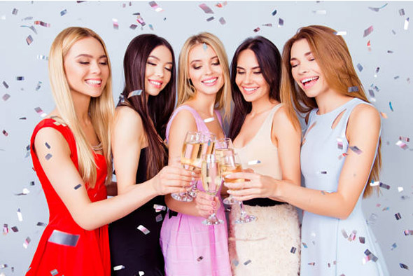 Ready to chill! Cheers to a bride! Five cute bridemaids and a future bride are toasting at the hen party, all in colorful cocktail outfits, so charming, attractive, festive, fancy and excited